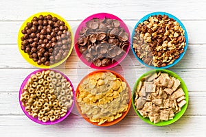 Various kids cereals in colorful bowls
