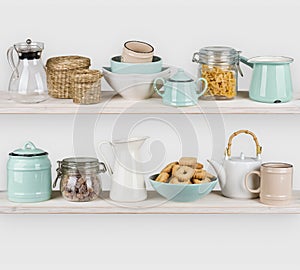 Various kitchen utensils and food ingredients isolated on wooden shelves