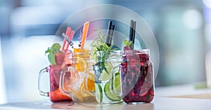 Various lemonades in mason jars with orange lime lemon otange st