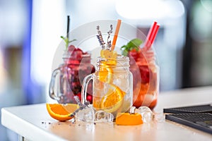 Various lemonades in mason jars with orange lime lemon otange st