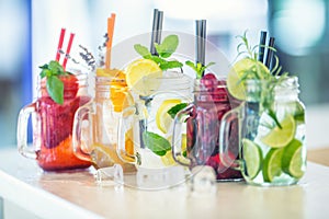 Various lemonades in mason jars with orange lime lemon otange st