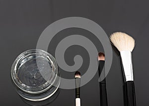 Various luxury makeup products on dark background, flat styling