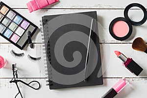 Various make-up products and cosmetics on wooden table