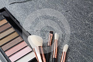 Various makeup products on dark
