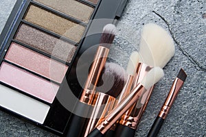 Various makeup products on dark background