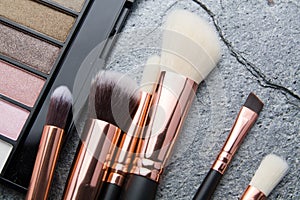 Various makeup products on dark background