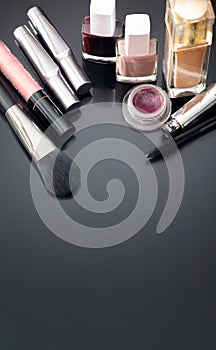 Various makeup products on a dark background