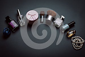 Various makeup products on dark background