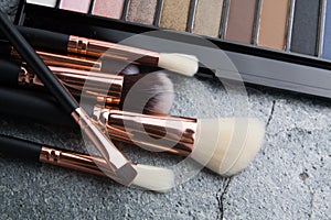 Various makeup products on dark background