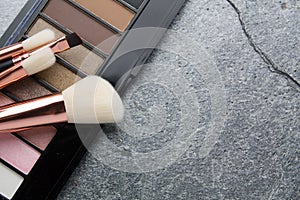 Various makeup products on dark background