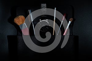 Various makeup products on dark background with copyspace background, fashion, frame, border, face, eye, facial, palette,