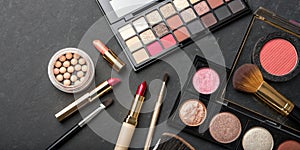 Various Makeup Products on Dark Background with Copyspace