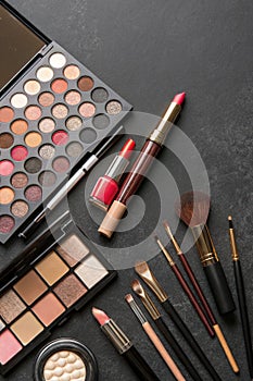 Various Makeup Products on Dark Background with Copyspace