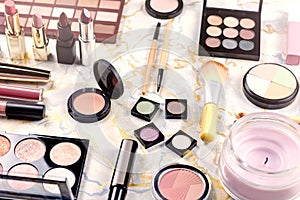 Various makeup products on table, flat design. Woman cosmetic essentials, top view