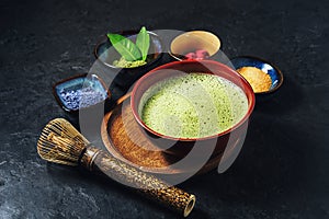 Various matcha tea powders on a dark concrete background.