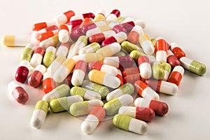 Various medical capsules on a light background