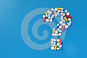 Various medicine pills arranged as question mark