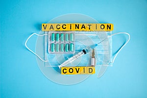 Various medicines on blue background for Vaccination against  Corona Virus. Concept of fight against coronavirus, vaccination,