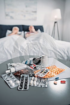 Various medicines and pill bottle on table