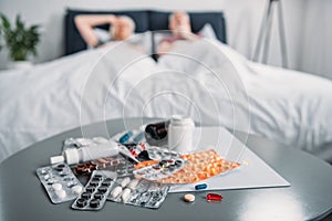 Various medicines and pill bottle on table