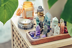 Various minerals and healing crystals on a wooden tray