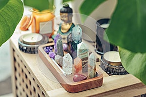 Various minerals and healing crystals on a wooden tray