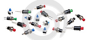 Various miniature push button switches isolated on white panoramic background photo