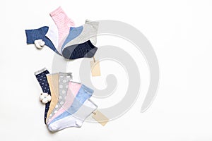 Various modern trendy women`s cotton socks set with cotton flowers and price tags on white background. Fashionable socks store.