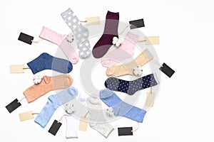 Various modern trendy women`s cotton socks set with cotton flowers and price tags on white background. Fashionable socks store.