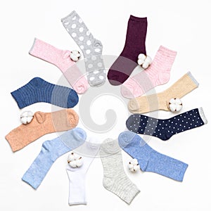 Various modern trendy women`s cotton socks set with cotton flowers on white background. Fashionable socks store. Socks shopping,