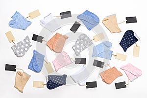 Various modern trendy women`s cotton socks set with price tags on white background. Fashionable socks store. Socks shopping, sale