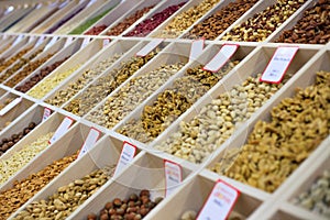 Various nuts and dried fruits on the market: hazelnuts, almonds, peanuts, cashews, raisins, candied fruits, dried fruits, prunes