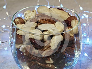 Various nuts in a glass container. Healthy dessert.