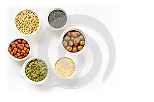 Various Nuts and Seeds on White Background in the Bowls with Free Space for Text