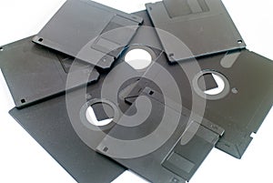 Various old obsolete 5 inch and 3 inch floppy disk on white