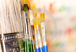 Various paint brushes in the transparent jar