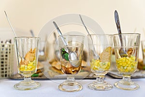 Various party snacks in glasses