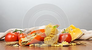 Various pasta, nest of thin vermicelli, scoop with farfalle, tom