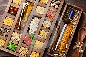 Various pasta in wooden box and wine