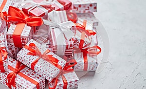 Various pattern and size Christmas boxes placed on white background. Wrapped in festive paper