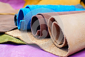 Various pieces of leather in rolls. Pieces of colored leather.