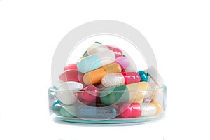 Various pills and capsules in glass containers symbole of medince addict