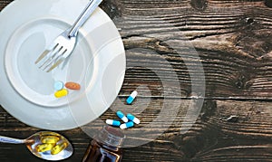 Various pills placed on the wooden floor