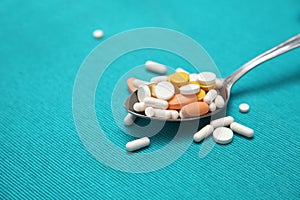 Various pills and tablets in spoon