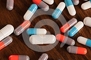 Various pills on wooden table - antibiotics