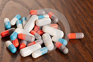 Various pills on wooden table - antibiotics