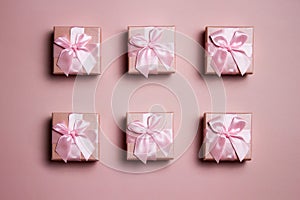 A various pink gift boxes pink red ribbon over the pink background.