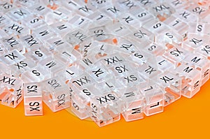 Various plastic clothing size tags, plastic size labels