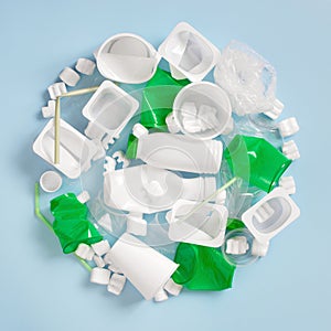 Various plastic garbage on the light blue background