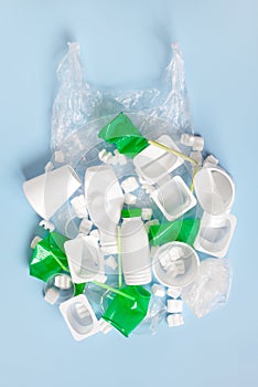 Various plastic garbage on the light blue background